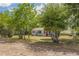 Exterior view of a single-story house with mature trees in the front yard at 47730 State Road 19, Altoona, FL 32702