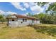 Rustic home featuring wood siding, a metal roof, and an expansive yard with mature trees at 47730 State Road 19, Altoona, FL 32702