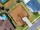 High aerial view featuring brown roof, nearby pool, and landscaping at 5062 Otters Den Trl, Sanford, FL 32771