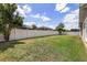 Green backyard featuring a white picket fence at 5062 Otters Den Trl, Sanford, FL 32771