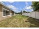 Large backyard with a white picket fence along the perimeter at 5062 Otters Den Trl, Sanford, FL 32771