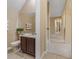 Well-lit powder room with modern fixtures, dark wood vanity, and neutral decor at 5062 Otters Den Trl, Sanford, FL 32771