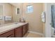 Well-lit bathroom featuring a vanity with countertop, a large mirror, and tiled flooring for a clean and modern feel at 5062 Otters Den Trl, Sanford, FL 32771