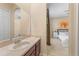 Practical bathroom featuring a vanity, ample counter space, and a view into the bedroom, creating a connected and harmonious space at 5062 Otters Den Trl, Sanford, FL 32771