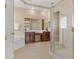 Luxurious bathroom featuring double sinks, a glass-enclosed shower, and a relaxing soaking tub at 5062 Otters Den Trl, Sanford, FL 32771