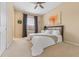 Bright bedroom with tan carpet features a large window and a bed with a patterned headboard at 5062 Otters Den Trl, Sanford, FL 32771