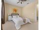 Bright bedroom with a ceiling fan, neutral walls, and a comfortable bed with a white comforter at 5062 Otters Den Trl, Sanford, FL 32771