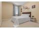 Inviting bedroom with a white comforter, accent wall decorations, and a bright window with curtains at 5062 Otters Den Trl, Sanford, FL 32771