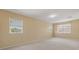 Spacious bonus room with neutral walls and carpet, with plenty of natural light from large windows at 5062 Otters Den Trl, Sanford, FL 32771