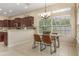Bright breakfast nook featuring a glass-topped table, modern chairs, and large windows with natural light at 5062 Otters Den Trl, Sanford, FL 32771