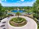 Gorgeous community entrance with lush landscaping, a serene pond with fountain, and an elegant gated entryway for a luxurious feel at 5062 Otters Den Trl, Sanford, FL 32771