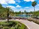 Elegant gated entrance to a lovely community with a serene lake and lush landscaping at 5062 Otters Den Trl, Sanford, FL 32771