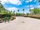 Gated community entrance features brick-paved drive, lush landscaping, and secure access at 5062 Otters Den Trl, Sanford, FL 32771
