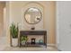 Foyer table with decorations, a mirror, a potted plant, tile flooring, and neutral paint at 5062 Otters Den Trl, Sanford, FL 32771