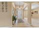 Bright foyer with a white front door, neutral walls, tile floors, and decorative art at 5062 Otters Den Trl, Sanford, FL 32771