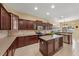 Spacious kitchen features dark wood cabinets, tile backsplash, and an island with wine rack at 5062 Otters Den Trl, Sanford, FL 32771