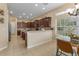 Bright kitchen boasts rich wood cabinetry, tile floors, and a sunlit breakfast nook with large windows at 5062 Otters Den Trl, Sanford, FL 32771