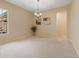 Neutral living room with light carpet, chandelier, and adjacent doorway to another room at 5062 Otters Den Trl, Sanford, FL 32771