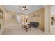 Inviting living room with neutral tones, ceiling fan, and ample natural light streaming through arched doorways at 5062 Otters Den Trl, Sanford, FL 32771