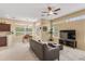 Bright and airy living space with a dining area, open kitchen, and large windows offering plenty of sunlight at 5062 Otters Den Trl, Sanford, FL 32771