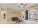 Open living room with neutral walls and carpet, black sofa, and doorways to adjacent rooms at 5062 Otters Den Trl, Sanford, FL 32771