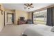 Bright main bedroom boasts a backyard view through a big window, complete with a dresser and comfy armchair at 5062 Otters Den Trl, Sanford, FL 32771