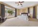Spacious main bedroom featuring a ceiling fan, large window, and a comfortable sitting area at 5062 Otters Den Trl, Sanford, FL 32771