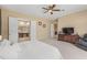 Serene main bedroom with access to a luxurious bathroom and a view of the living area for seamless living at 5062 Otters Den Trl, Sanford, FL 32771