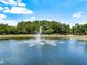 Picturesque pond with a fountain feature, surrounded by lush trees and landscaping for a peaceful, scenic community amenity at 5062 Otters Den Trl, Sanford, FL 32771
