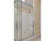 Bright bathroom shower with a tile floor and bench and glass doors, providing a comfortable and stylish showering experience at 5062 Otters Den Trl, Sanford, FL 32771