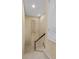 Carpeted staircase with wood railing leading to the next floor, accented with wall decorations at 5062 Otters Den Trl, Sanford, FL 32771