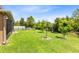 Beautifully maintained backyard with grass, trees, and shrubs at 613 Crownclover Ave, Orlando, FL 32828