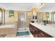 Bright bathroom with a soaking tub, a glass shower, and dual sinks at 613 Crownclover Ave, Orlando, FL 32828