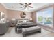 Cozy bedroom featuring a comfortable bed, soft lighting, and a ceiling fan at 613 Crownclover Ave, Orlando, FL 32828