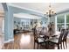 Charming dining room with hardwood floors, an elegant chandelier, and comfortable seating, perfect for meals at 613 Crownclover Ave, Orlando, FL 32828