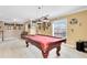 Amusement awaits in this game room, highlighting a pool table with themed decor and a well-lit space at 613 Crownclover Ave, Orlando, FL 32828