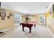 Spacious game room with a well-lit pool table and decorative Steelers memorabilia throughout at 613 Crownclover Ave, Orlando, FL 32828