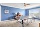 Game room offering a ping pong table, plush carpet, and a serene blue color scheme at 613 Crownclover Ave, Orlando, FL 32828
