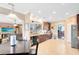 Open kitchen with dark wood cabinetry, granite countertops, tile floors, and stainless steel appliances at 613 Crownclover Ave, Orlando, FL 32828
