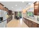 A modern kitchen features wooden cabinets, stainless steel appliances, and a breakfast nook, perfect for Gathering meals at 613 Crownclover Ave, Orlando, FL 32828