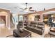 Spacious living room boasts an open floor plan, tile floors, and comfortable seating, seamlessly connected to other living spaces at 613 Crownclover Ave, Orlando, FL 32828