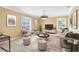 Bright living room with modern furnishings, neutral colors, and large windows at 613 Crownclover Ave, Orlando, FL 32828
