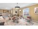 This bright living room offers a unique chandelier, contemporary art, and window views at 613 Crownclover Ave, Orlando, FL 32828