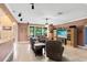 Inviting living room featuring tile flooring and comfortable leather seating with a window overlooking the outdoors at 613 Crownclover Ave, Orlando, FL 32828