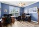 Well-lit home office with dual workstations, tiled floors, and a ceiling fan at 613 Crownclover Ave, Orlando, FL 32828