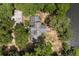 An aerial view of a unique home surrounded by lush greenery and a tranquil body of water at 613 Lake Ave, Altamonte Springs, FL 32701
