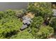 An aerial view of a house surrounded by lush green trees, next to a tranquil lake at 613 Lake Ave, Altamonte Springs, FL 32701