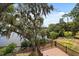 Scenic backyard view showcasing lush greenery, waterfront, and a charming wooden deck at 613 Lake Ave, Altamonte Springs, FL 32701