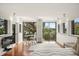 Well-lit bedroom with large windows, desk and chair, offering a tranquil view of the outdoors at 613 Lake Ave, Altamonte Springs, FL 32701