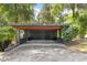 Spacious carport with a modern design, surrounded by lush greenery and mature trees at 613 Lake Ave, Altamonte Springs, FL 32701